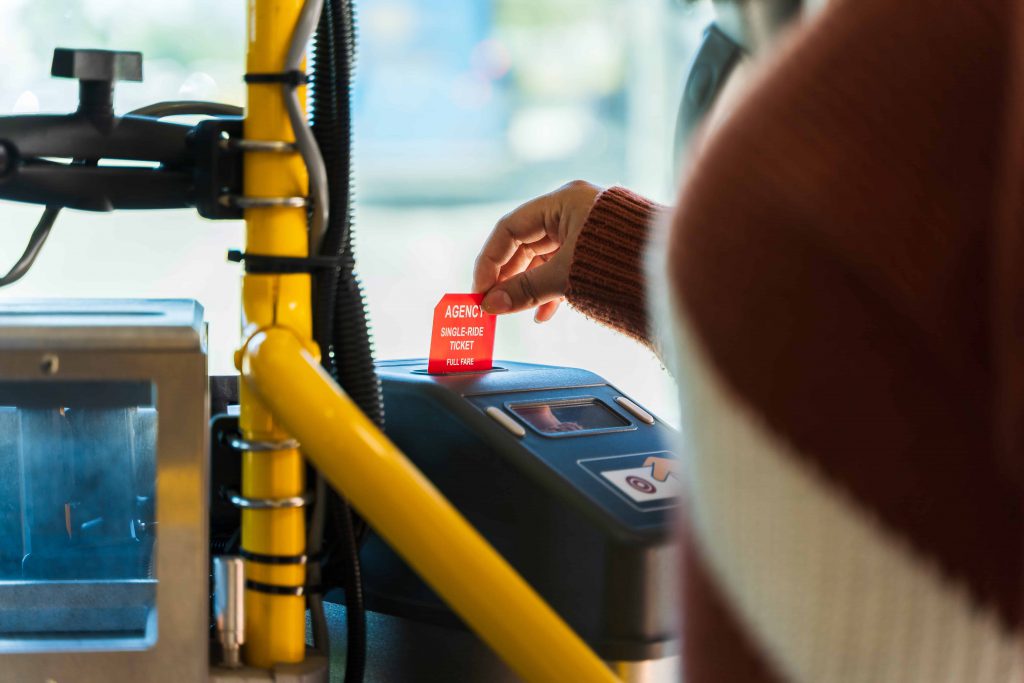 Person using pass on bus