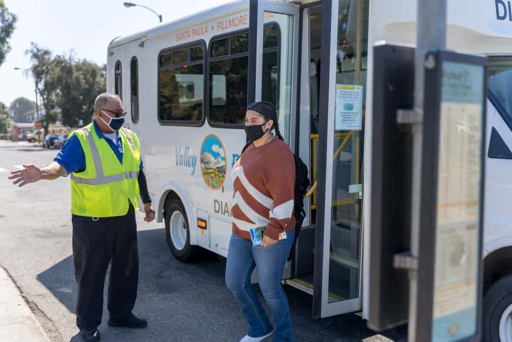 Student rider getting off bus stop